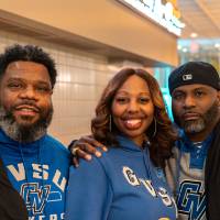 Three event guests with GVSU sweatshirts on posing for photo